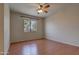 Unfurnished bedroom with hardwood floors, ceiling fan and window with neighborhood view at 1335 E June St # 221, Mesa, AZ 85203