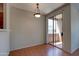 An unfurnished dining room with hardwood floors and sliding door access to a balcony at 1335 E June St # 221, Mesa, AZ 85203