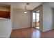 An unfurnished dining room with hardwood floors and sliding door access to a balcony at 1335 E June St # 221, Mesa, AZ 85203