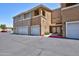 Exterior view of townhome with multiple garages, highlighting the convenient parking at 1335 E June St # 221, Mesa, AZ 85203