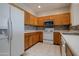 Kitchen with stainless appliances, mosaic tile backsplash, and white refrigerator at 1335 E June St # 221, Mesa, AZ 85203