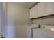Laundry room with white washer and dryer and upper white cabinets at 1335 E June St # 221, Mesa, AZ 85203