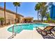 Community pool with lounge chairs and palm trees, perfect for relaxation and leisure at 1335 E June St # 221, Mesa, AZ 85203