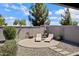 Backyard with desert landscaping, featuring lounge chairs on a paved area, perfect for relaxing outdoors at 1364 W Spine Tree Ave, Queen Creek, AZ 85140
