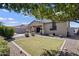 Spacious backyard featuring a grassy area, desert landscaping, a covered patio, and a privacy fence at 1364 W Spine Tree Ave, Queen Creek, AZ 85140