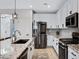 Updated kitchen featuring stainless steel appliances, granite countertops, white cabinets, and tiled backsplash at 1364 W Spine Tree Ave, Queen Creek, AZ 85140