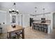 Open floor plan with a kitchen featuring a granite breakfast bar, stainless appliances, and a dining area at 1364 W Spine Tree Ave, Queen Creek, AZ 85140