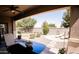 Relaxing back porch with outdoor furniture and a view of the landscaped backyard at 1364 W Spine Tree Ave, Queen Creek, AZ 85140