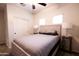 Bright bedroom features a ceiling fan, natural light, and closet with sliding doors at 1364 W Spine Tree Ave, Queen Creek, AZ 85140