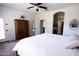 Primary bedroom featuring a ceiling fan, light walls, carpet, and ensuite bathroom at 1364 W Spine Tree Ave, Queen Creek, AZ 85140