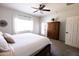 Bright bedroom features a ceiling fan, light walls, and carpet at 1364 W Spine Tree Ave, Queen Creek, AZ 85140