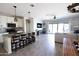 Open concept living room featuring a kitchen island with granite countertops and stainless appliances at 1364 W Spine Tree Ave, Queen Creek, AZ 85140