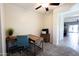 Bright office space with wood desk, blue chair, and carpeted floors at 1364 W Spine Tree Ave, Queen Creek, AZ 85140