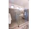 Glass enclosed shower with built-in shelving, dual shower heads, and three windows at 1364 W Spine Tree Ave, Queen Creek, AZ 85140