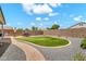 Landscaped backyard features artificial turf, stone accents and ample seating at 1384 E Leslie Ave, San Tan Valley, AZ 85140