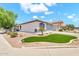 Charming single story home with desert landscaping, palm tree, and two-car garage at 1384 E Leslie Ave, San Tan Valley, AZ 85140