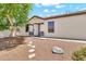 Inviting front entrance with a white door framed by stone accents and desert landscaping at 1384 E Leslie Ave, San Tan Valley, AZ 85140