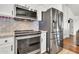 Well-equipped kitchen with stainless steel appliances, white cabinetry, and a stylish backsplash at 1384 E Leslie Ave, San Tan Valley, AZ 85140