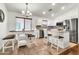 Bright kitchen and dining area with stainless steel appliances, a breakfast bar, and ample counter space at 1384 E Leslie Ave, San Tan Valley, AZ 85140