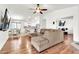 Open-concept living area with a large sectional couch and seamless transition to the dining and kitchen areas at 1384 E Leslie Ave, San Tan Valley, AZ 85140