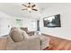 Bright living room featuring a large sectional sofa and wall-mounted TV for relaxing evenings at 1384 E Leslie Ave, San Tan Valley, AZ 85140