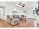 Spacious living room with a comfortable sectional sofa, ceiling fan and hardwood floors at 1384 E Leslie Ave, San Tan Valley, AZ 85140