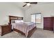 Spacious bedroom featuring a ceiling fan, neutral carpet, and plentiful natural light from a window at 1384 E Leslie Ave, San Tan Valley, AZ 85140