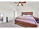 Serene main bedroom with carpet floors, a wooden bed frame, and ample natural light at 1384 E Leslie Ave, San Tan Valley, AZ 85140