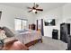 Bright bedroom with carpet, ceiling fan, TV, and large window for ample natural light at 1384 E Leslie Ave, San Tan Valley, AZ 85140