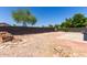 Large backyard with gravel and tile accents, surrounded by desert landscaping at 13862 W Fargo Dr, Surprise, AZ 85374
