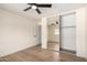 Bedroom featuring hard flooring, ceiling fan and a mirror sliding door closet at 13862 W Fargo Dr, Surprise, AZ 85374
