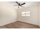Neutral bedroom featuring hard flooring, one window and ceiling fan at 13862 W Fargo Dr, Surprise, AZ 85374