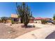 Well-maintained home featuring desert landscaping, a two-car garage, and a clay tile roof at 13862 W Fargo Dr, Surprise, AZ 85374