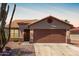 Charming single-story home with a well-maintained front yard, complemented by desert landscaping and a two car garage at 13862 W Fargo Dr, Surprise, AZ 85374