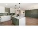Modern kitchen opens to living area, featuring an island with quartz countertop and stainless appliances at 13862 W Fargo Dr, Surprise, AZ 85374