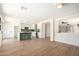 Bright, open-concept kitchen features white cabinets, an island with seating, and modern pendant lighting at 13862 W Fargo Dr, Surprise, AZ 85374