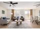 Open-concept living area with abundant natural light, stylish furniture, and wood-look flooring at 13862 W Fargo Dr, Surprise, AZ 85374