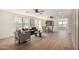 Bright, open-concept living room and dining room with light wood floors and abundant natural light at 13862 W Fargo Dr, Surprise, AZ 85374