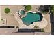 Aerial shot of a backyard pool, spa, and patio area with lush landscaping at 14572 W Medlock Dr, Litchfield Park, AZ 85340