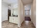 Bright bathroom with white cabinets, granite counters, and a walk-in shower at 14572 W Medlock Dr, Litchfield Park, AZ 85340