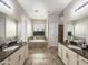 Elegant bathroom with double vanities, a soaking tub, and neutral color scheme at 14572 W Medlock Dr, Litchfield Park, AZ 85340