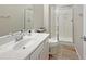 Well-lit bathroom with a glass-enclosed shower and white single vanity at 14572 W Medlock Dr, Litchfield Park, AZ 85340