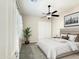 Clean bedroom with a window, ceiling fan, double door closet, and a plant at 14572 W Medlock Dr, Litchfield Park, AZ 85340