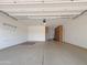 Spacious garage with epoxy flooring and cabinet storage for organization at 14572 W Medlock Dr, Litchfield Park, AZ 85340