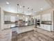 Well-equipped kitchen with a large island, stainless steel appliances, and ample storage at 14572 W Medlock Dr, Litchfield Park, AZ 85340