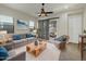 Comfortable living room with plush seating, modern decor, and backyard access at 14572 W Medlock Dr, Litchfield Park, AZ 85340