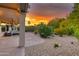 View of the backyard with desert landscaping, plants and cacti, and the covered patio at 15928 W Zinnia Ct, Surprise, AZ 85374