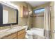 This bathroom features a granite vanity top, a tub/shower combo with tile surround, and tile flooring at 15928 W Zinnia Ct, Surprise, AZ 85374