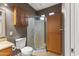 Bathroom featuring a glass door shower, storage cabinets, a toilet, and natural lighting at 15928 W Zinnia Ct, Surprise, AZ 85374