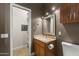 Bathroom featuring a vanity, toilet, a mirror, and a walk in closet at 15928 W Zinnia Ct, Surprise, AZ 85374